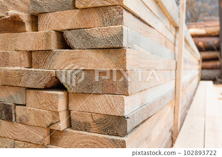 Fresh cut pine logs at a sawmill close-up. Timber processing at the sawmill. 102893722
