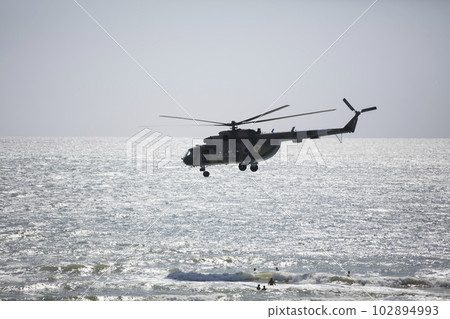 Ukraine. Odessa region, August 30, 2019. Central beach. Helicopter flies over the sea Ukraine. Odessa region, August 30, 2019. Central beach. Helicopter flies over the sea 102894993