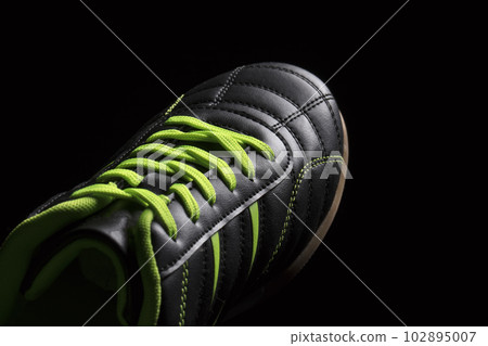 Fragment of a black sneaker closeup. Part of leather sports shoes 102895007