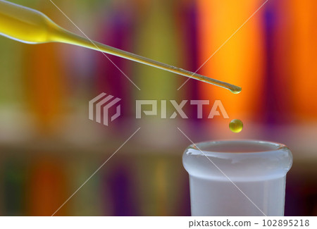 Dropper with falling drop of chemical 102895218