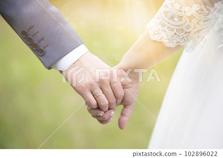 Hands of the bride and groom. The concept of marriage. Hands of the bride and groom. The concept of marriage. 102896022