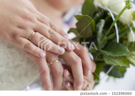 Hands of the bride and groom on a wedding bouquet. Wedding day. Hands of the bride and groom on a wedding bouquet. Wedding day. 102896060