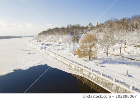 Winter landscape. The river and the city covered with snow 102896067