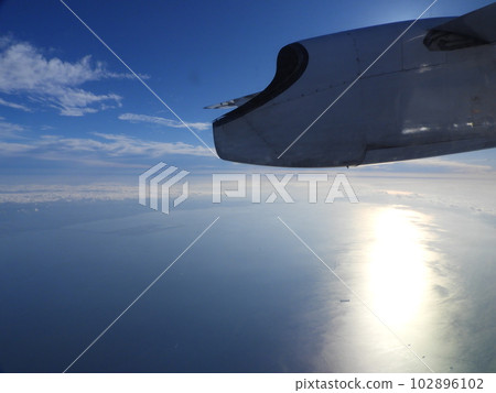 Sunlight illuminating the sea seen from inside the plane Sunlight illuminating the sea seen from inside the plane 102896102