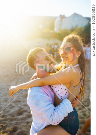 Beautiful couple enjoy each other on Holi festival Friendship, Leisure, Vacation, Togetherness. 102896839