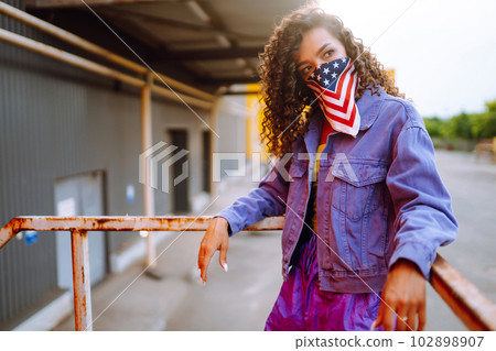 Funky young woman with american bandana dancing alone in the street.Sport, dancing and urban culture 102898907