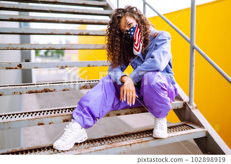 Funky young woman with american bandana dancing alone in the street.Sport, dancing and urban culture 102898919