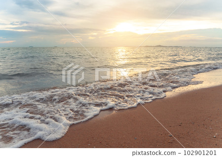 Seawater soft wave crashing on sandy beach seaside in summer on sunset time. summer vacation activity background concept.. Seawater soft wave crashing on sandy beach seaside in summer on sunset time. summer vacation activity background concept.. 102901201