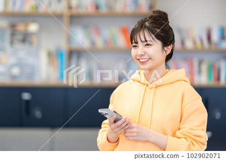 A college student using a smartphone. 102902071
