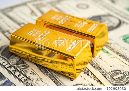 Gold bar on US dollar banknotes money, economy finance exchange trade investment concept. 102902080