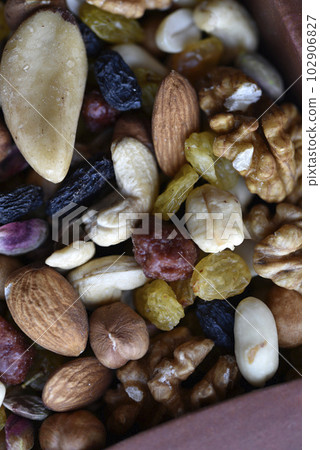 Assorted nuts in a box close-up. Delicious different nuts in a box. 102906827