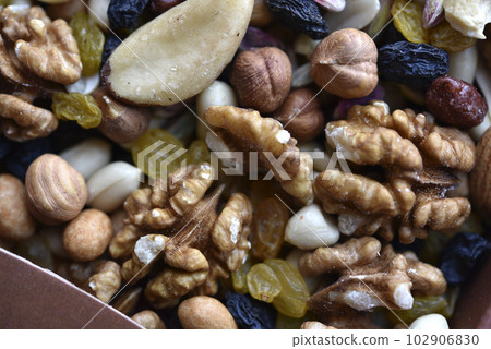 Assorted nuts in a box close-up. Delicious different nuts in a box. Assorted nuts in a box close-up. Delicious different nuts in a box. 102906830