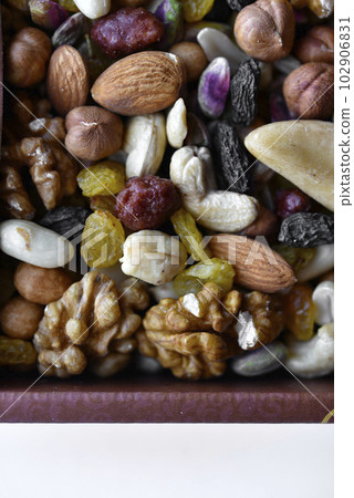 Assorted nuts in a box close-up. Delicious different nuts in a box. Assorted nuts in a box close-up. Delicious different nuts in a box. 102906831