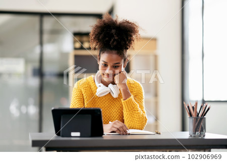 African american student woman in sweater watching e-learning to African american student woman in sweater watching e-learning to 102906969