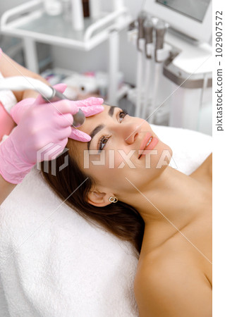cosmetic facial procedure,Facial treatment. The skincare specialist is executing a cosmetic process on a fresh-faced lady,Aqua rejuvenation cosmetic facial procedure,Facial treatment. The skincare specialist is executing a cosmetic process on a fresh-faced lady,Aqua rejuvenation 102907572
