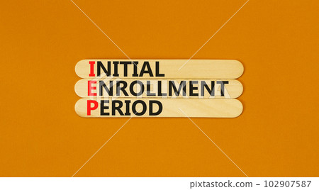 IEP symbol. Concept words IEP Initial enrollment period on beautiful wooden sticks. Beautiful orange table orange background. Medical and IEP Initial enrollment period concept. Copy space. 102907587