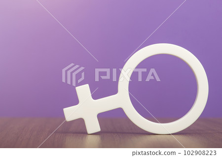 Gender symbol of a woman. Woman symbol on purple background with copy space. The concept of a woman leader or gender equality. 102908223