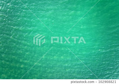 Aerial view of seascape surface of green sea water with small ripple waves 102908821