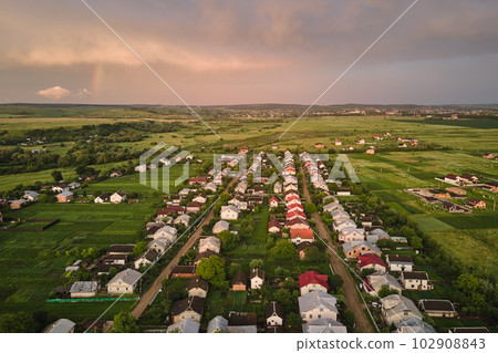 Aerial view of residential houses in suburban rural area at sunset 102908843