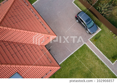 Aerial view of private house with ceramic shingles covered roof top. Investment in real estate concept 102908857