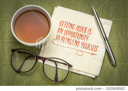 getting older is an opportunity to reinvent yourself - inspirational note on a napkin, healthy aging and personal development concept 102908982