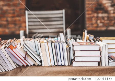 Pile of books on table outdoor. Abstract blurred background . Education, school, study, reading literature 102911137