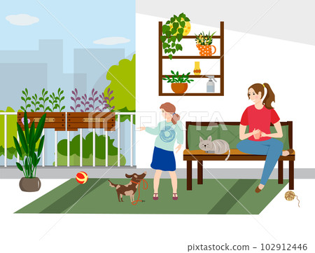 The family is relaxing on the balcony. The girl is playing with the dog, the cat is resting on the couch.  102912446