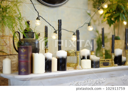 Decorations set made from candles, lanterns and plants and other accessories are on the shelf at the reception of a hotel, restaurant or at a wedding party. Decorations set made from candles, lanterns and plants and other accessories are on the shelf at the reception of a hotel, restaurant or at a wedding party. 102913759