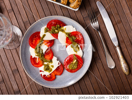 Caprese salad with tomato, mozzarella and balsamic dressing Caprese salad with tomato, mozzarella and balsamic dressing 102921403