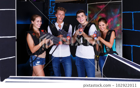 Young people posing with laser pistols Young people posing with laser pistols 102922011