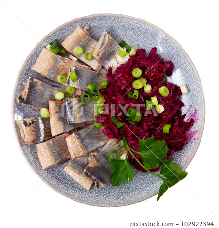 On blue plate-pieces of salted herring fillet,decorated parsley and green onion,with stewed beets On blue plate-pieces of salted herring fillet,decorated parsley and green onion,with stewed beets 102922394