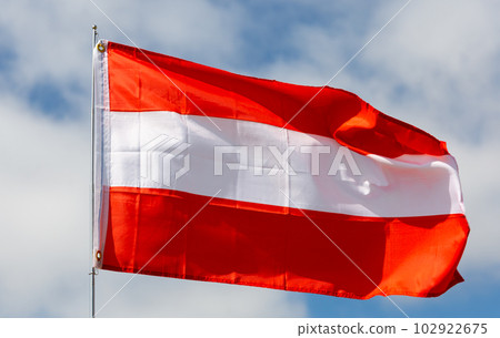 Flag of Austria waving on cloudy sky during daytime Flag of Austria waving on cloudy sky during daytime 102922675