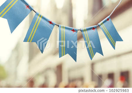 A garland of Aruba national flags on an abstract blurred background 102925983