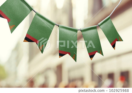 A garland of Zambia national flags on an abstract blurred background A garland of Zambia national flags on an abstract blurred background 102925988