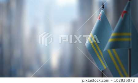 Small flags of the Aruba on an abstract blurry background 102926078