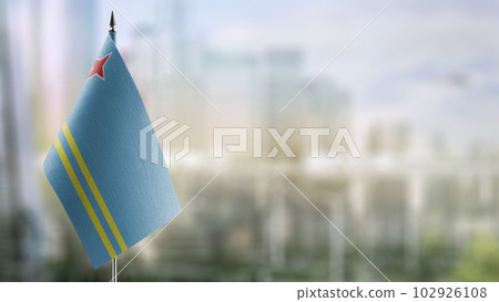 Small flags of the Aruba on an abstract blurry background 102926108
