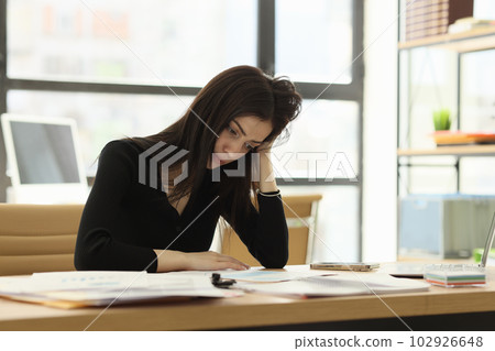Upset office worker looks at wrong done report at desk 102926648