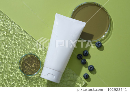 White tube placed on acrylic sheet with glass petri dish filled with fluid extracted from Blueberry. Blueberries contain anti-inflammatory properties that help treat psoriasis and eczema White tube placed on acrylic sheet with glass petri dish filled with fluid extracted from Blueberry. Blueberries contain anti-inflammatory properties that help treat psoriasis and eczema 102928541