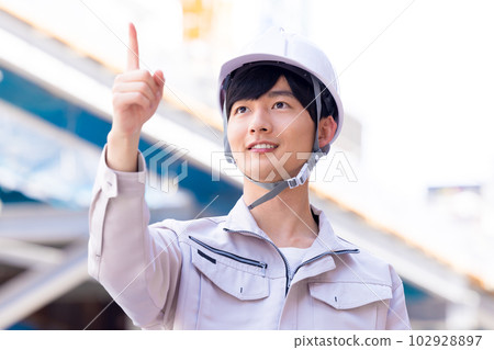 Business A man in work clothes working at a construction site 102928897