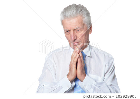 close up portrait of senior businessman in formal wear praying isolated close up portrait of senior businessman in formal wear praying isolated 102929903