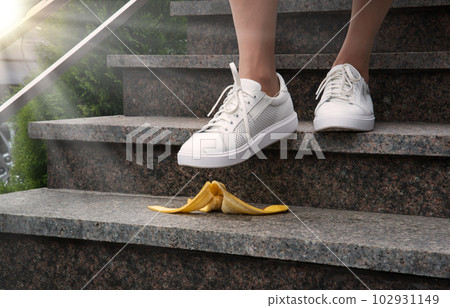 Foot stepping on a banana peel on steps Foot stepping on a banana peel on steps 102931149