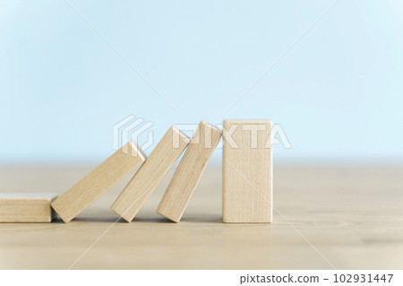 Falling wooden domino cubes. Insurance, business, risk, management concept. 102931447