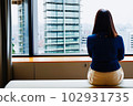 A woman looking out through the window 102931735