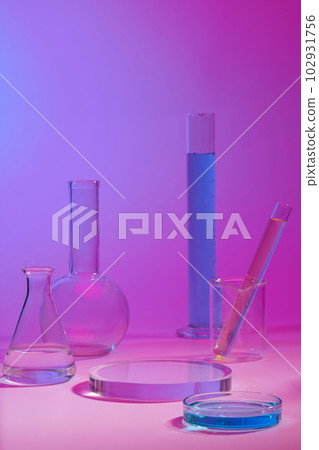 Podium in round shape for beauty product promotion. Laboratory glassware filled with colorful liquid displayed Podium in round shape for beauty product promotion. Laboratory glassware filled with colorful liquid displayed 102931756