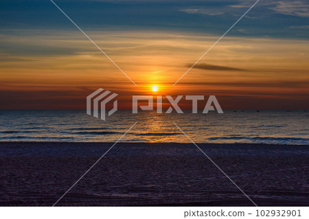 Spectacular bright golden sunset over Baltic sea 102932901