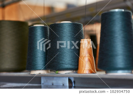 Three bobbins with industrial threads on cones 102934750