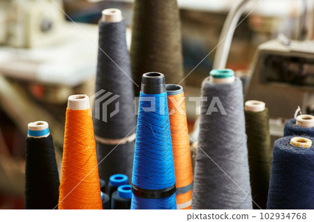 A few almost used bobbins with knitting threads A few almost used bobbins with knitting threads 102934768