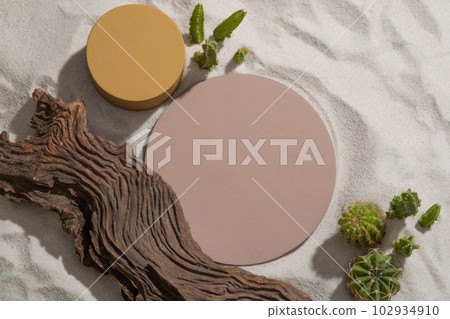 Round and cylinder-shaped podium in pastel color over the beach sand. Modern minimal showcase scene for cosmetic products promotion Round and cylinder-shaped podium in pastel color over the beach sand. Modern minimal showcase scene for cosmetic products promotion 102934910