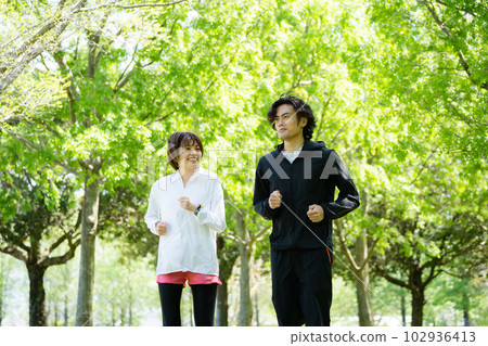 couple running in the park couple running in the park 102936413