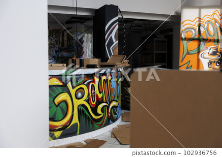 Demolished structure turned into chaos and disintegration, abandoned warehouse looking grungy and dirty. Neglected building filled with garbage, walls covered in dust and debris. 102936756